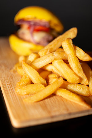 Yellow Mini Gourmet Burger with French Fries on wooden board