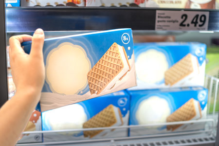 Hand taking Ice Cream stocked on supermarket for selling and ready for consumptionの写真素材