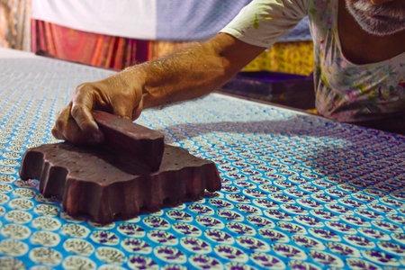 Artisan hand stamping patterns in ink with block on traditional Indian textilesの写真素材
