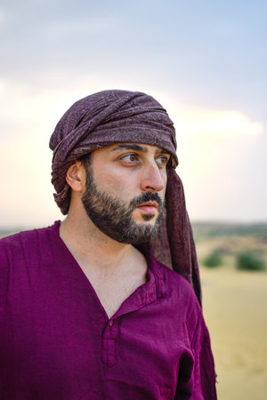 Portrait of Mature Masculine model with beard looking desert sunset calmの写真素材