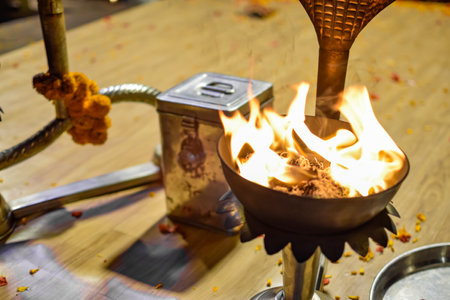 Fire lamp burning and donation box at Aarti ceremony on Ganges, Varanasiの写真素材