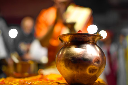 Close up image Bowl of Aarti ceremony with Pujari or Indian priest in backgroundの写真素材