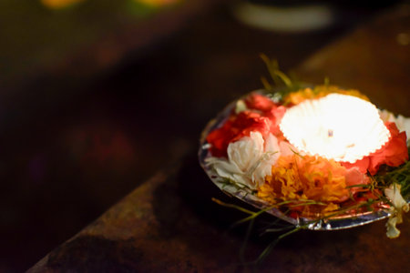 Close up Colored offering with candle and flowers in floating on bank of Gangesの写真素材