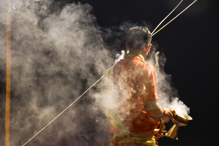 Pujaris or Indian priests performing Aarti ceremony on banks of Ganges in crowdの写真素材