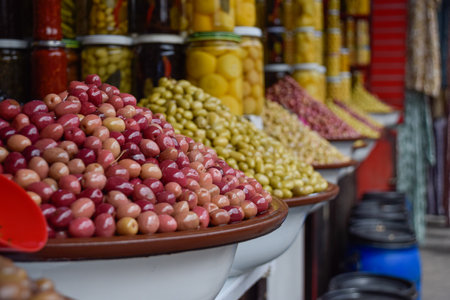 Different Olives displayed in local market with pickle jars in backgroundの写真素材