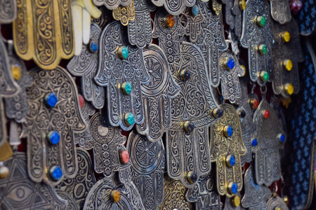 Hands of Fatima in Metal hanging from a street stall in the Marrakech soukの写真素材