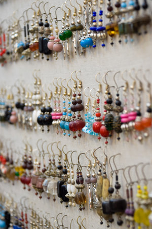 Lot of Earrings in different colors and shapes exposed in local market at Marrakechの写真素材