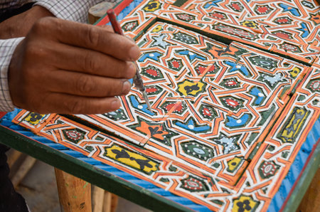 Hand painting in wooden decorative window in craft shop, Marrakechの写真素材