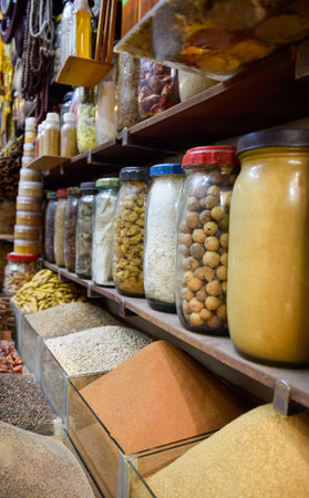 Bottled spices like curry and turmeric displayed in bazaar market in Marrakeshの写真素材