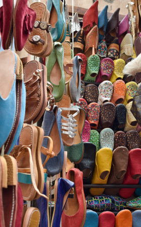 Slippers or sandals of many colors hung from street stalls in Marrakechs soukの写真素材