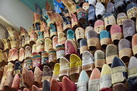 Slippers or sandals of many colors hung from street stalls in Marrakechs souk