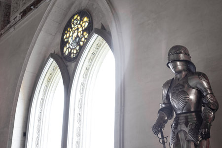 Front view Detailed Medieval shiny armor and gothic pointed arches in backgroundの写真素材