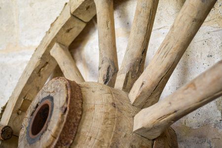Antique wooden carriage wheel exposed on the streetの写真素材