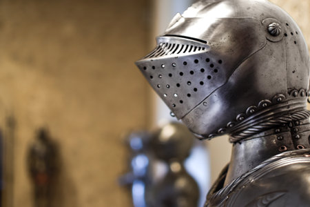 Close up view of Medieval shiny Helmet with details and armors in backgroundの写真素材