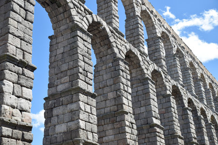 Tilted bottom view of Segovia Aqueduct, Roman construction for transporting waterの写真素材