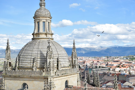 Gothic Cathedral of Segovia with pinnacles, vault and village in backgroundの写真素材