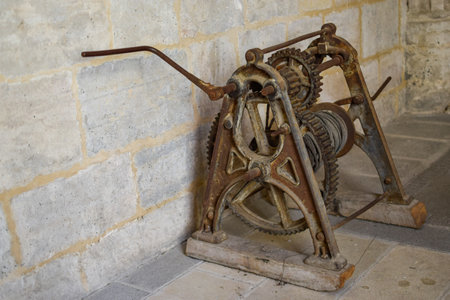 Old machine with large gears and lever to turn and bring ropeの写真素材