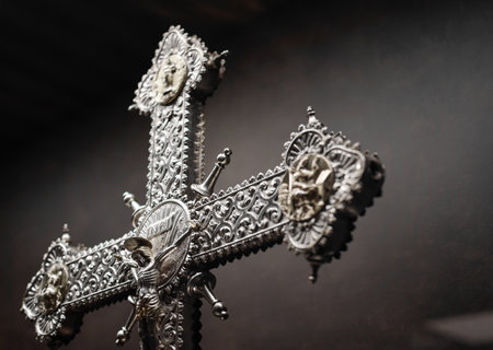 Silver crucifix in medieval Gothic style exposed with a background in shadesの写真素材