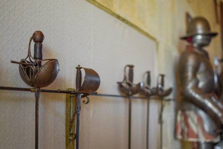 Set of Medieval Swords Exposed with a White Background of Castle wall and Armorの写真素材