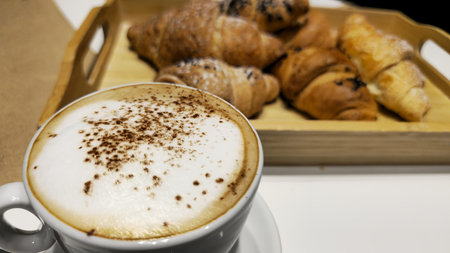 Delicious Coffee and Fresh Croissants on a Wooden Tray