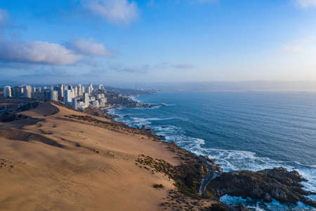 Aerial view of dunes, pacific ocean and buildings at Concon, Chileの写真素材