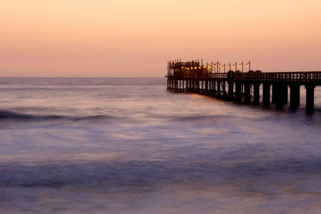 Famous jetty in Swakopmund, a germam style colonial city on the Atlantic coast of northwestern Namibiaの写真素材