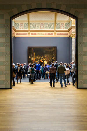 AMSTERDAM, NETHERLANDS - FEBRUARY 08: Visitor at Rijksmuseum admiring ?Night Watch?, By Rembrandt Harmensz. van Rijn, on February 08, 2015 in Amsterdam. The Rijksmuseum is located at the Museum Square, and first opened its doors in 1885.のeditorial素材