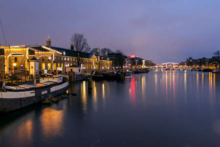Magere Brug (Skinny Bridge). A famous traditional double leaf Dutch bascule bridge connecting the two sides of the river Amstel, in Amsterdam, the Netherlands. The original bridge was built in 1691.のeditorial素材