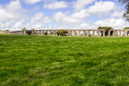 Agua de Prata Aqueduct (Aqueduct of Silver Water) in Evora, Portugal. Its huge arches stretching for 9 kilometres (6 miles), this aqueduct was built in 15311537 by King Joao III to supply the city with water.の写真素材