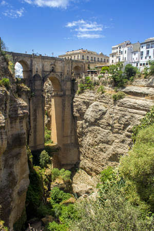 Ronda Panoramic view over Puente Nuevo, New Bridge The newest and largest of three bridges that span the 120-metre deep chasm that carries the GuadalevÃ­n River and divides the city of Ronda, in southern Spain. Built between 1759-1793, the architect was Jの写真素材