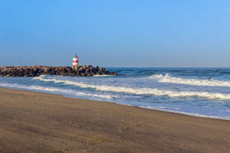 Ocean view and small lighthouse in the inlet jetty of Tavira Island Algarve Portugal.の写真素材