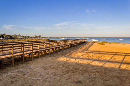 Algarve Cavacos beach footbridge and seascape at Ria Formosa wetlands reserve, southern Portugal, famous nature destination.の写真素材