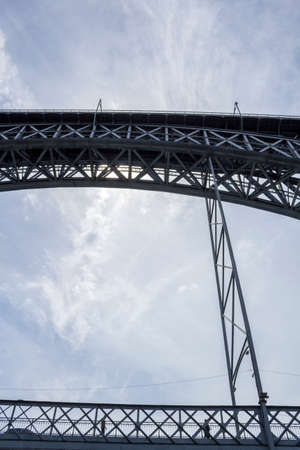 Detail of Dom Luiz Bridge in blue sky background, Porto cityscape, on a summer day, Portugal.