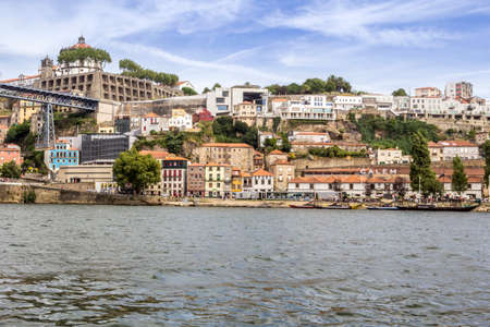 Panoramic from Douro river tour boat, view of Dom Luiz Bridge and Gaia riverbank, Porto cityscape, Portugal.のeditorial素材