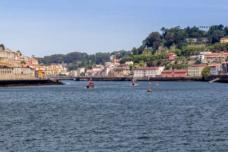 View of Ribeira historical quarter, on the margin Douro river embankment, Porto, Portugal.
