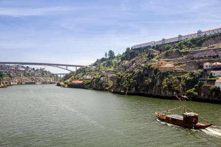 Panoramic view of Douro River, Porto landscape and tradicional Rabelo boats, on a summer day, Portugal.の写真素材