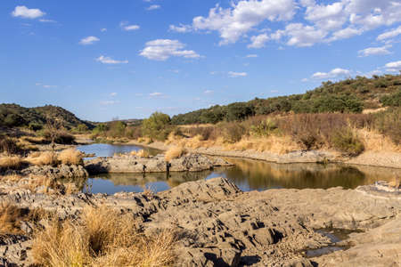 Countryside landscape scenic view of a fresh water stream on a natural park trail, in the Alentejo tourism destination region, Portugal.の写真素材