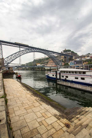 View of Ribeira historical quarter, on the margin Douro river embankment Oporto old town and  Luis I...