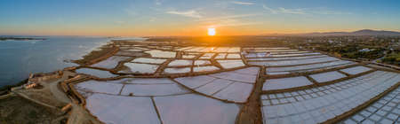 Sunset aerial panoramic view, in Ria Formosa wetlands natural park, salt production pans in the foreground, Algarve. Portugal.の写真素材