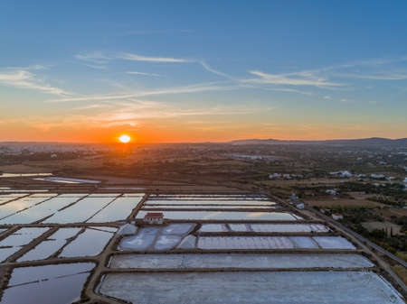 Sunset aerial view, in Ria Formosa wetlands natural park, salt production pans in the foreground, Algarve. Portugal.の写真素材