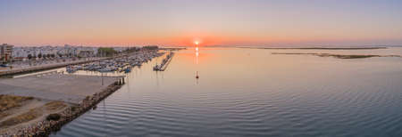 Sunrise aerial seascape view of Olhao salt marsh Inlet, waterfront to Ria Formosa natural park. Algarve. Portugal.の写真素材