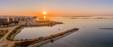 Sunrise aerial seascape view of Olhao salt marsh Inlet, waterfront to Ria Formosa natural park. Algarve. Portugal.の写真素材