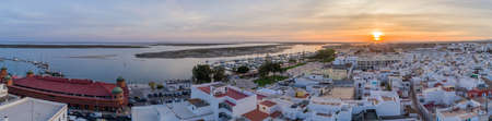 Sunset aerial cityscape in Olhao, Algarve fishing village view of ancient neighbourhood of Barreta, and its traditional cubist architecture. Portugal.の写真素材