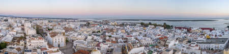 Sunset aerial cityscape in Olhao, Algarve fishing village view of ancient neighbourhood of Levante, and its traditional cubist architecture. Portugal.の写真素材