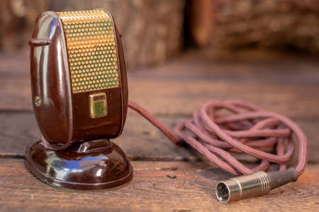 Close up shot of a antique 50s microphone with cables and box, vintage retro style media concept.の写真素材