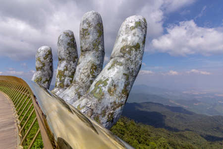 Da Nang, Vietnam - October 31, 2018: Golden Bridge known as âHands of Godâ, a pedestrian footpath lifted by two giant hands, open in July 2018 and a landmark at the famous tourist destination of Ba Na Hills in Da Nang, Vietnam.のeditorial素材