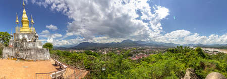 The golden stupa on the top of Mount Phou Si in Luang Prabang, Laos.の写真素材