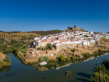 Aerial view of the town of MÃ©rtola in southeastern Portuguese Alentejo destination region, located in the margin of Guadiana River, whit its medieval castle, located on the highest point. Portugal.の写真素材