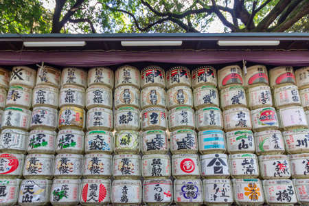 TOKYO, JAPAN - NOVEMBER 04, 2019: Consecrations of Meiji Jingu Shinto shrine, traditional sake wine barrels pattern background in Yoyogi park located at Shibuya, Tokyo.のeditorial素材