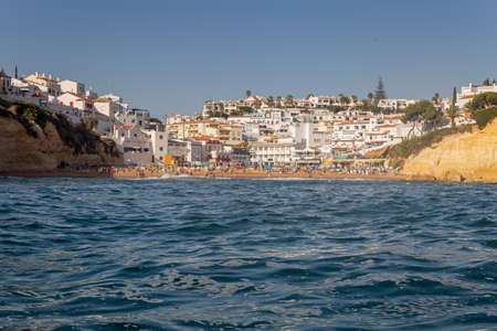 Carvoeiro typical village and beach, view from seashore, in Algarve tourism destination region, Portugal.の写真素材